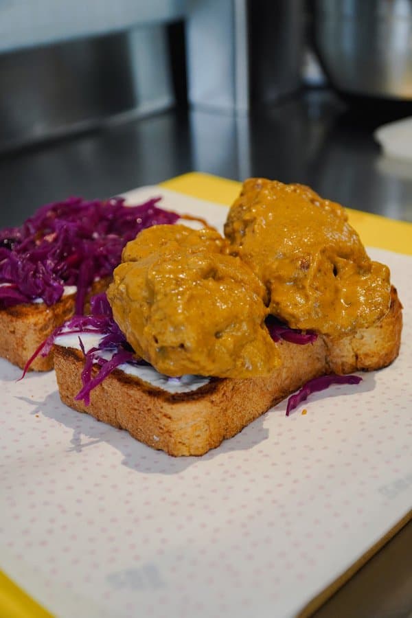 Fuwamai spiced meatball open sando with curry sauce and red cabbage slaw on toasted shokupan