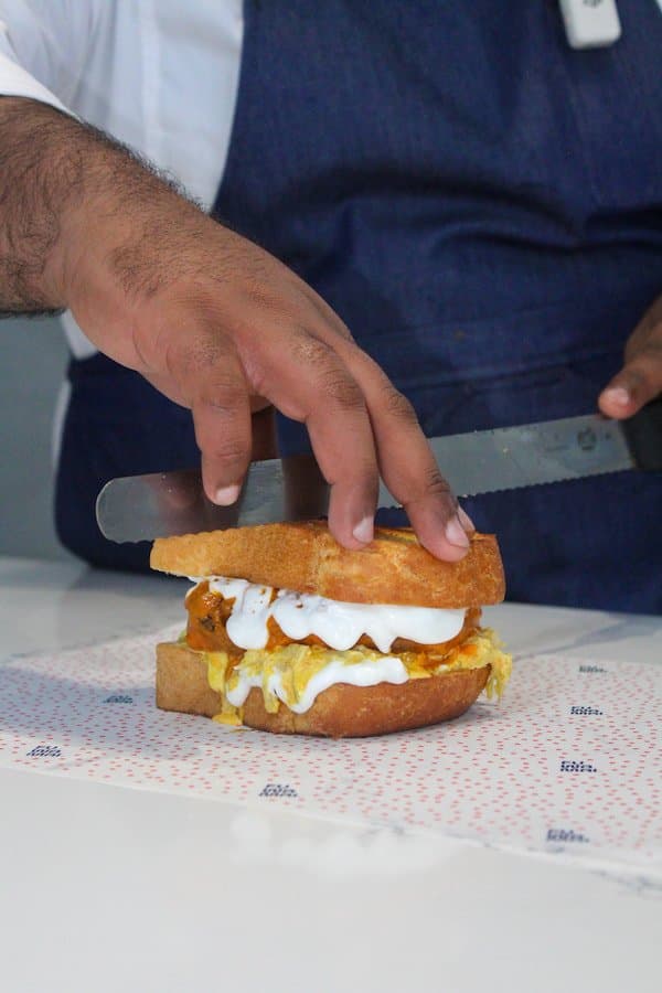 Fuwamai chef preparing a creamy curry chicken sando on Japanese milk bread